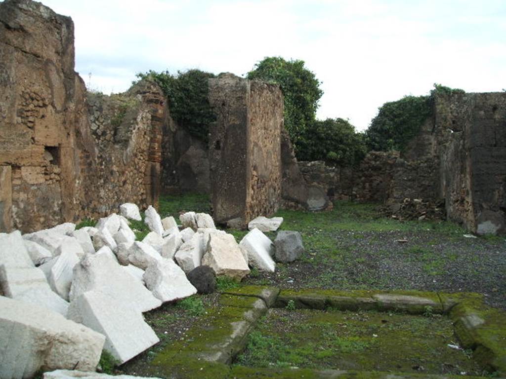 VIII.3.31 Pompeii. December 2004. Looking towards doorway to an exedra in the north-east corner of atrium, and the tablinum, on its right. 
