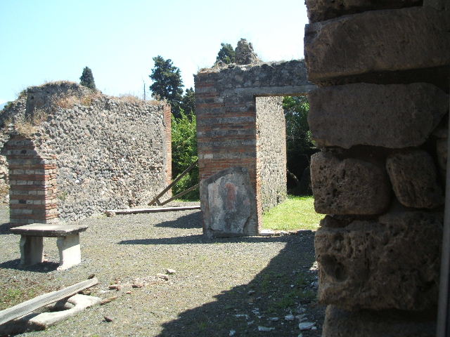 VIII.4.9 from VIII.4.8 Pompeii. May 2005. Looking south to arched recess.