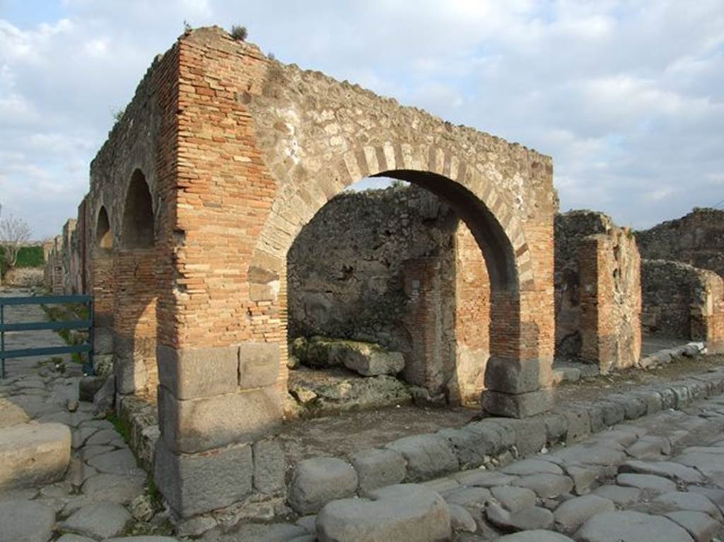 IX.2.1 Pompeii. December 2006. Three arches containing street altar, looking east from Via Stabiana.
In October 1847, painted on two of these pilasters on the north-west corner of IX.2, were found

Suedium  o(ro)  v(os)  f(aciatis)    [CIL IV 905]

Fa]ustinum
aed(ilem)  o(ro)  v(os)  f(aciatis)    [CIL IV 906]

P(ublium)  Sittium    [CIL IV 907]

L(ucium)  C(eium)  S(ecundum)  II vir(um)  o(ro)  v(os)  f(aciatis)
Iaello
rog(at)    [CIL IV 908]

See PAH II, 475 and
See Pagano, M. and Prisciandaro, R., 2006. Studio sulle provenienze degli oggetti rinvenuti negli scavi borbonici del regno di Napoli. Naples : Nicola Longobardi.  (p.164)

