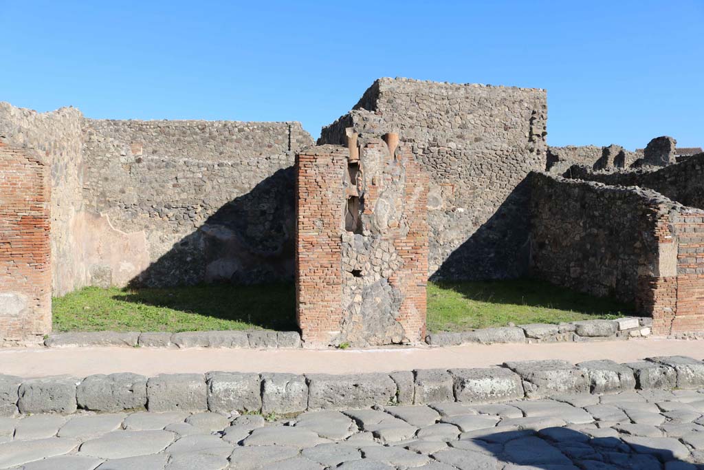IX.2.2, on left, and IX.2.3, on right. December 2018. 
Looking east to entrance doorways on Via Stabiana, with downpipe between. Photo courtesy of Aude Durand.
