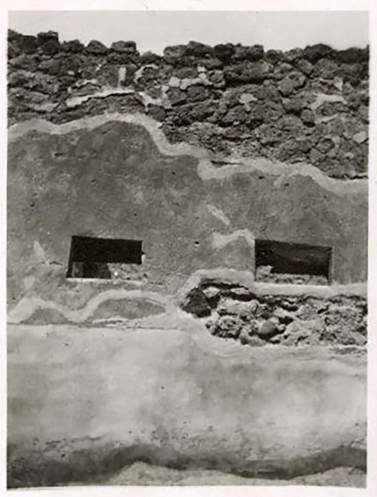 IX.2.15 Pompeii. Pre-1943. Photo by Tatiana Warscher.
Two windows of an unusual shape, on west side of doorway, giving light from Vicolo into room in south-west corner of IX.2.15/16. 
See Warscher, T. Codex Topographicus Pompeianus, IX.2. (1943), Swedish Institute, Rome. (no.47.), p. 108.
