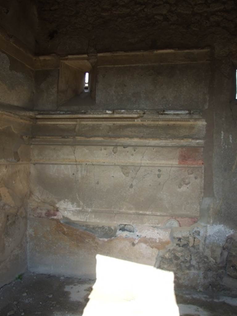 IX.2.17 Pompeii. March 2009. Room 2, cubiculum. East wall with small window onto Vicolo di Tesmo. The walls in this room preserved the traces of Ist Style decoration. 

