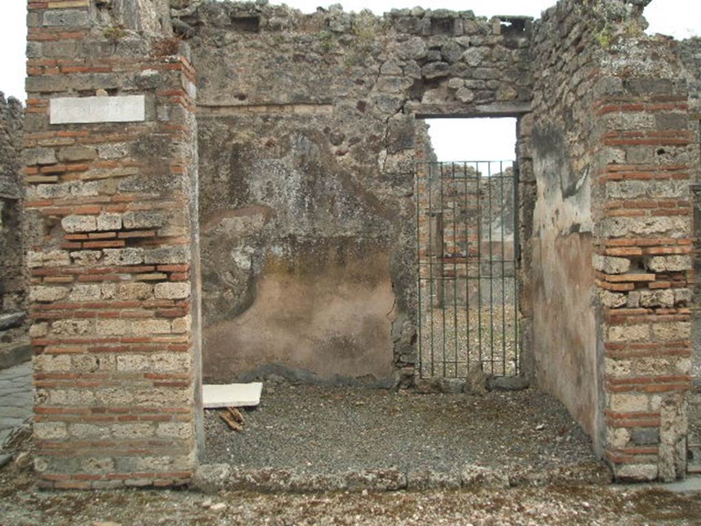 IX.2.20 Pompeii. May 2005. Looking south across shop, to doorway to atrium of IX.2.21. According to Della Corte, the following electoral recommendations were found here on the facade, (see also IX.3.20)

Casellium  aed(ilem)
Pyramus  rog(at)     [CIL IV 3703]                          

Bruttium  Balbum
II vir(um)
Hic  aerarium  conservabit
Gen[ialis]
rog(at)      [CIL IV 3702]

See Della Corte, M., 1965.  Case ed Abitanti di Pompei. Napoli: Fausto Fiorentino. (p. 193)

