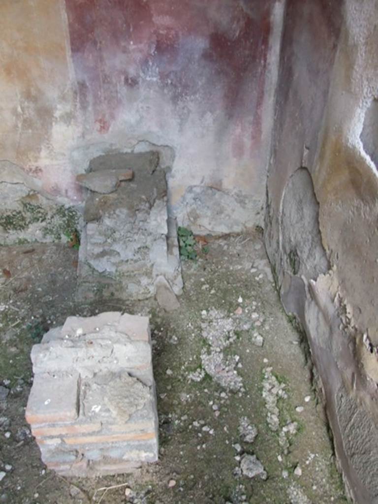IX.2.21 Pompeii. March 2009. Room 2, south-west corner. According to Boyce, found in this room that Fiorelli described as un cubiculo divenuto Larario, was  a square brick base with a depression in its upper surface for a statue base and in front of it was a square brick altar.
See Boyce G. K., 1937. Corpus of the Lararia of Pompeii. Rome: MAAR 14. (p.81, no. 400) 


