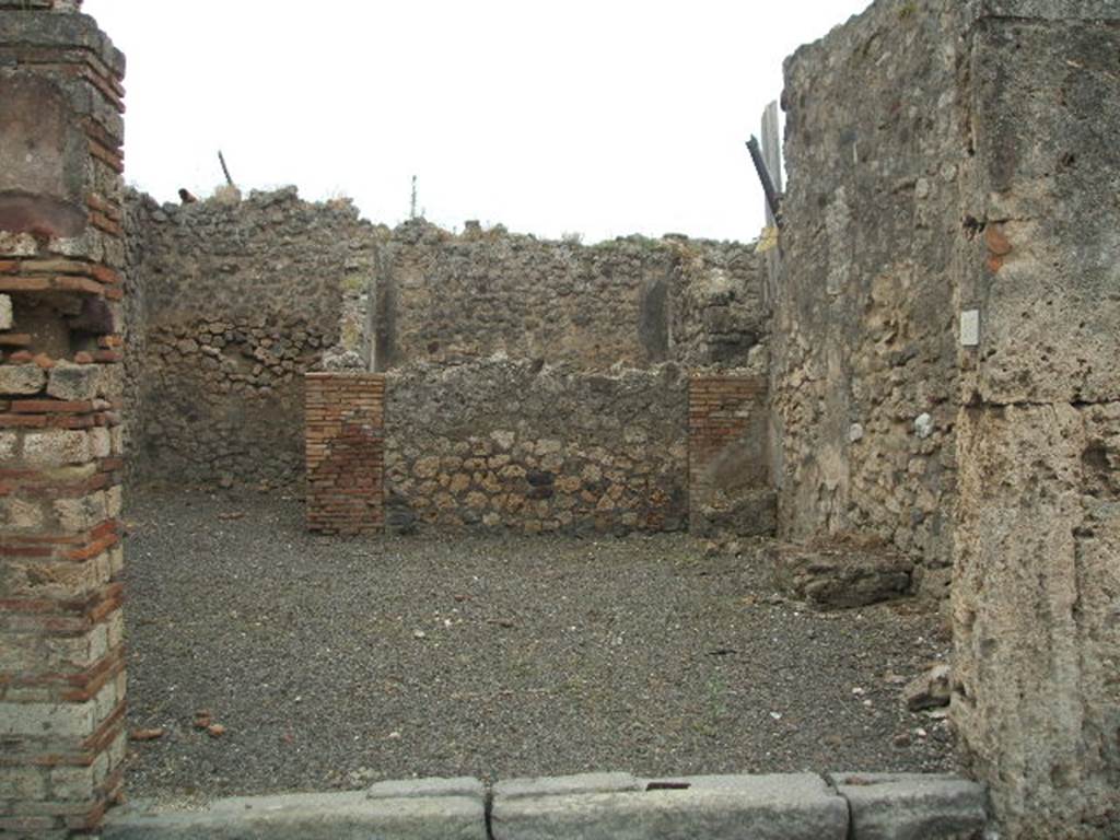 IX.2.25 Pompeii. May 2005. Entrance, looking south. On the left at the rear is a room for the customers.  On the right can be seen the remains of three supports for a podium along the west wall. According to Eschebach, the stairs to the upper floor would also have been on the right. Fiorelli does not mention any. According to Della Corte, he thought this caupona was a dependence of the owner of the house next door, Casellio. The caupona had a hearth or cooker, table or bench of wood held up by three supports of brick and a room for the clients. He thought it was managed by Thyrsus, as appeared from the recommendation written on the right of the entrance:
Thyrsus  facit    [CIL IV 3640]
See Della Corte, M., 1965.  Case ed Abitanti di Pompei. Napoli: Fausto Fiorentino. (p. 195)
The full recommendation appears to have been:
I beg you to elect Cn. Helvius Sabinus aedile, worthy of public office. Thyrsus votes for him.   [CIL IV 3640]
See Cooley, A. and M.G.L., 2004. Pompeii : A Sourcebook. London : Routledge. (p. 121, F39)