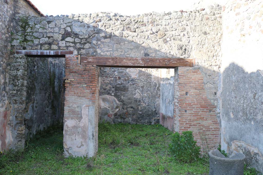 IX.3.19 Pompeii. December 2018. 
Looking north across shop-room of bakery, the corridor to the bakery is on the left. Photo courtesy of Aude Durand.

