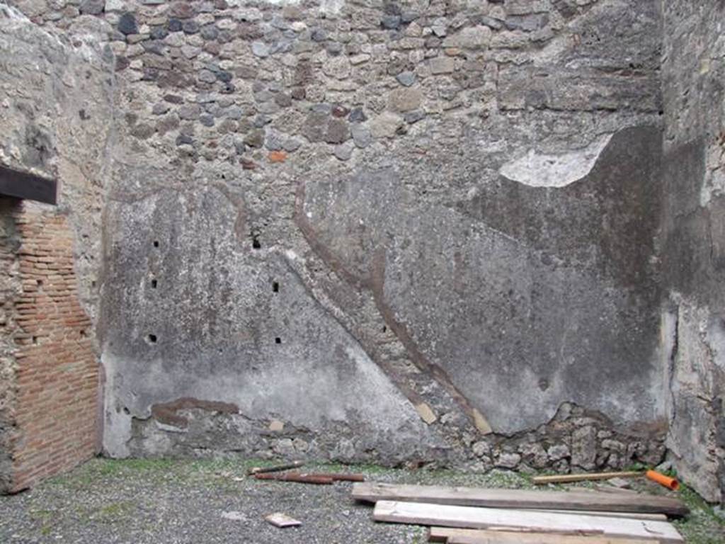IX.3.19 Pompeii. December 2007. Room 10, the shop-room with the outline of staircase to upper floor, which is visible on the east wall. Below the stairs would have been a small storeroom/cupboard, with remains of shelving supports on the east wall.
