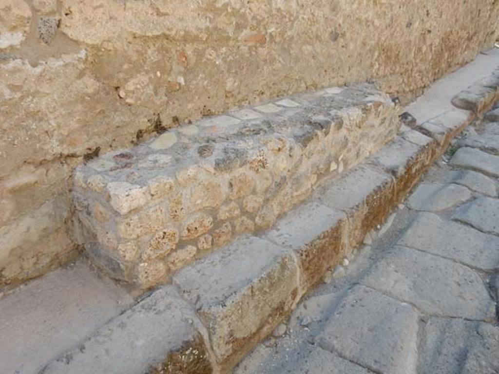 IX.3.20 Pompeii. May 2017. Bench outside entrance doorway on west side of Vicolo di Tesmo. Photo courtesy of Buzz Ferebee.
