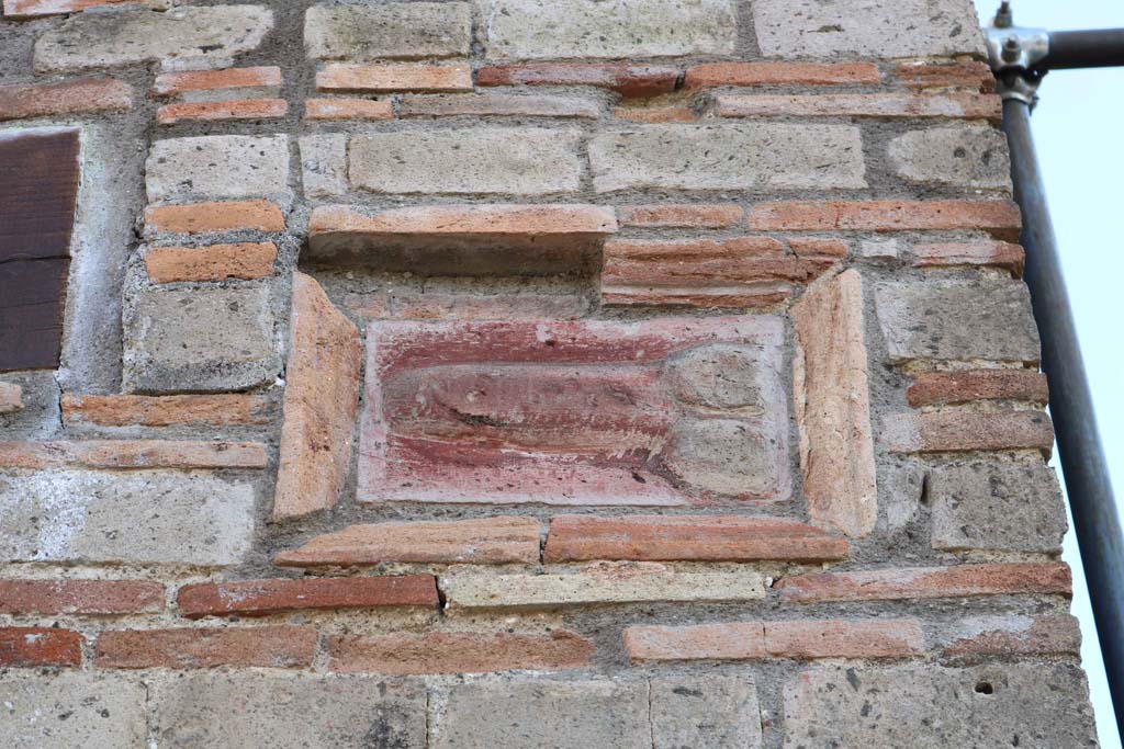 IX.5.1 Pompeii. December 2018. 
Terracotta wall plaque of phallus on wall on west side of entrance doorway. Photo courtesy of Aude Durand.

