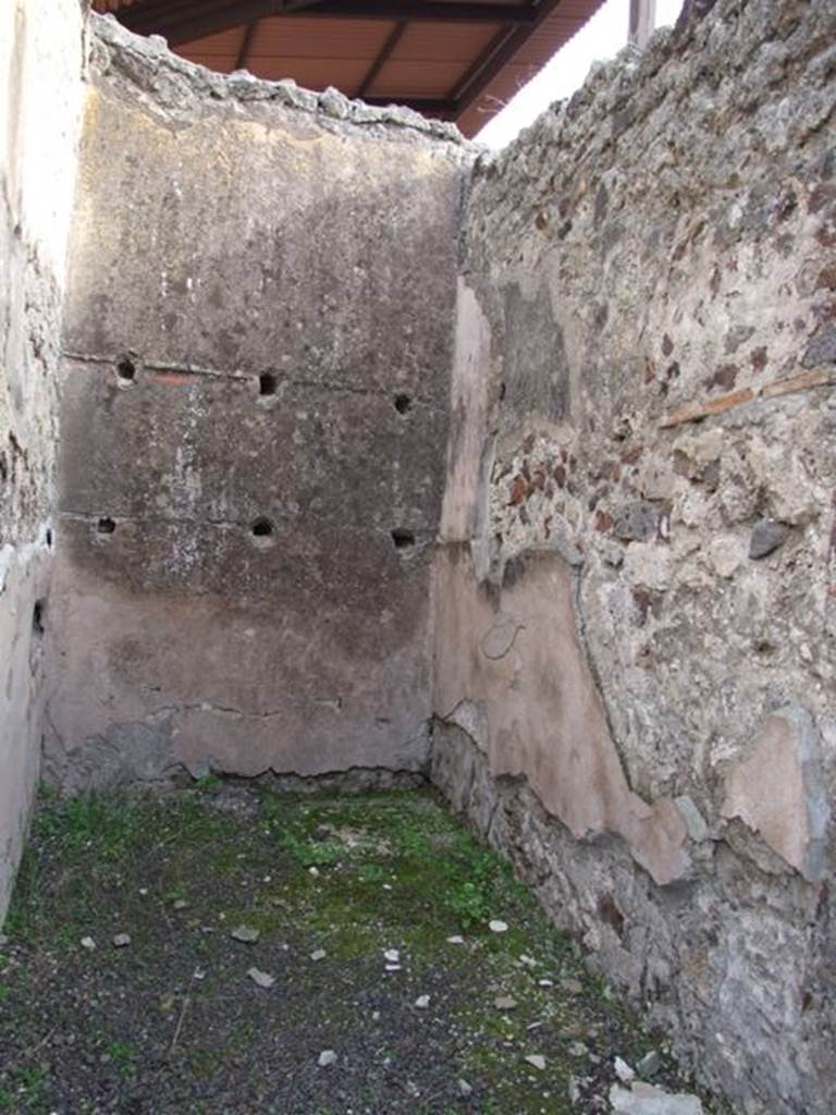 IX.5.9 Pompeii. December 2007. Room 6, small storeroom or cupboard, looking east.  On the rear wall are the holes left by the supports for the shelving. 

