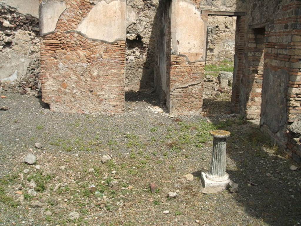 IX.6.3 Pompeii. May 2005. 
Looking north across atrium and site of impluvium to doorways to three small rooms, “b”, “c”, and “d”.
The edge of the impluvium was made of opus signinum of crushed brick, and ornamented with irregular pieces of marble and black and white stones arranged in rows. 
Instead the bottom of the impluvium was formed of black and white mosaic, without a recognisable design. 
The circular marble table with a grooved foot was found behind it.  

