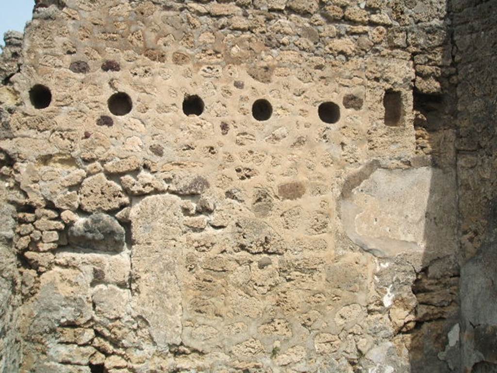 IX.6.4 Pompeii. May 2005. Wall with holes for joists of upper floor.