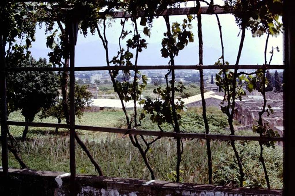 Looking east, Pompeii. 1973. View from the Casina dell’Aquila above IX.7.12 across IX.7, IX.12 (still unexcavated), towards IX.13.1-3 (with roof). Photo by Stanley A. Jashemski. 
Source: The Wilhelmina and Stanley A. Jashemski archive in the University of Maryland Library, Special Collections (See collection page) and made available under the Creative Commons Attribution-Non Commercial License v.4. See Licence and use details. J73f0241
