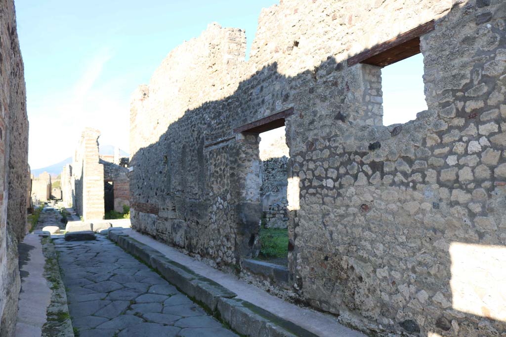 IX.7.21 Pompeii. December 2018. Looking north along east side of Vicolo di Tesmo, towards entrance doorway. Photo courtesy of Aude Durand.