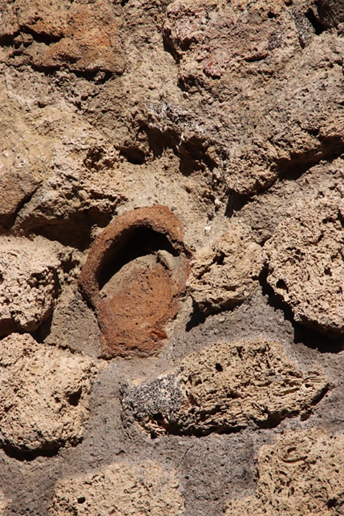 IX.7.21 Pompeii. Pompeii. October 2022. 
Terracotta decoration embedded in wall. Photo courtesy of Klaus Heese. 

