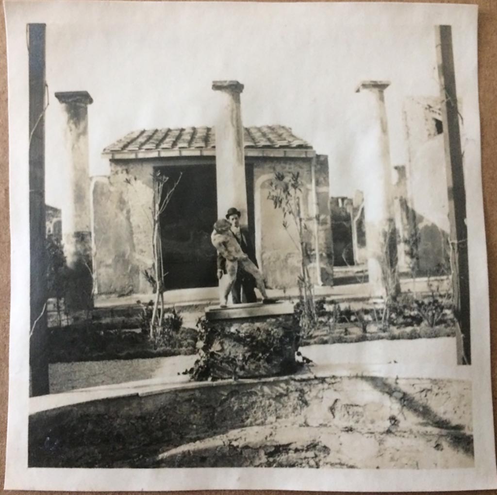IX.8.6 Pompeii. August 27, 1904. Looking north across pool in peristyle, towards copy of statue of satyr with wineskin. 
Photo courtesy of Rick Bauer.
