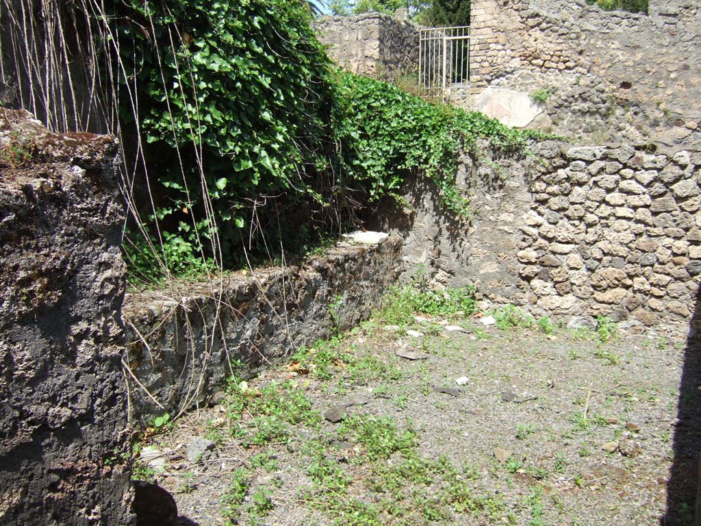 IX.10.2 Pompeii. May 2006. Kitchen 3 north-west corner with stone bench, to west of entrance.
