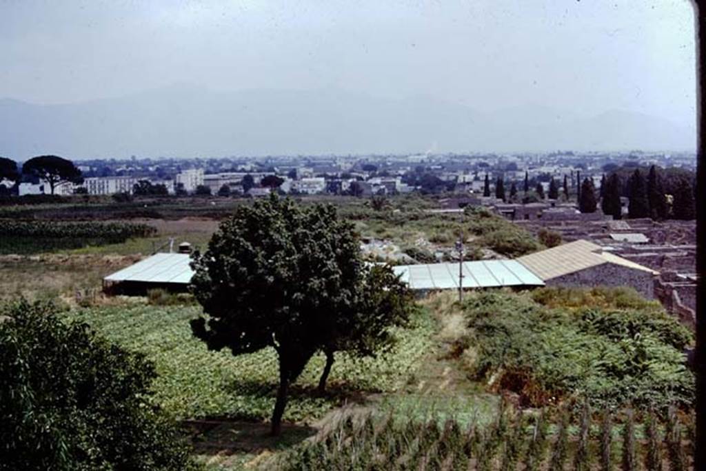 IX.13.1-3 Pompeii, 1973. Looking east from Casina dell’Aquila towards IX.13.1-3 with roof, across the top of the unexcavated IX.12.  Photo by Stanley A. Jashemski. 
Source: The Wilhelmina and Stanley A. Jashemski archive in the University of Maryland Library, Special Collections (See collection page) and made available under the Creative Commons Attribution-Non Commercial License v.4. See Licence and use details. J73f0239
