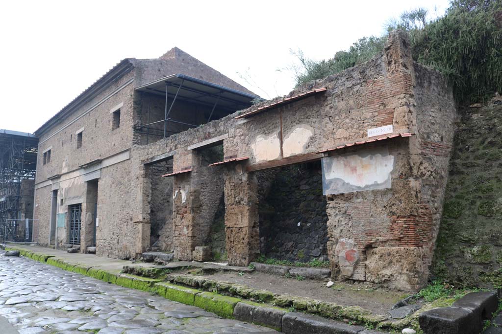IX.13.6 Pompeii, on right. December 2018. 
Looking west along front façade from IX.13.6 towards IX.13.1, on left. Photo courtesy of Aude Durand.
