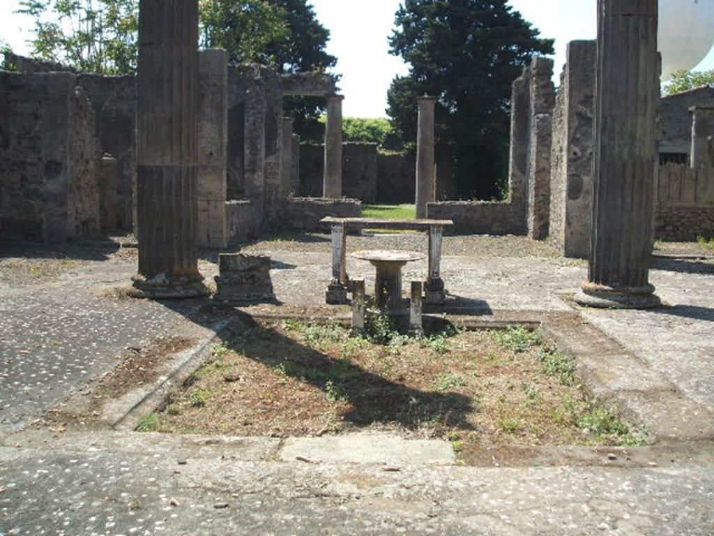 IX.14.4 Pompeii. May 2005. Looking south across atrium towards tufa impluvium. In the centre was a circular marble fountain disc (a).