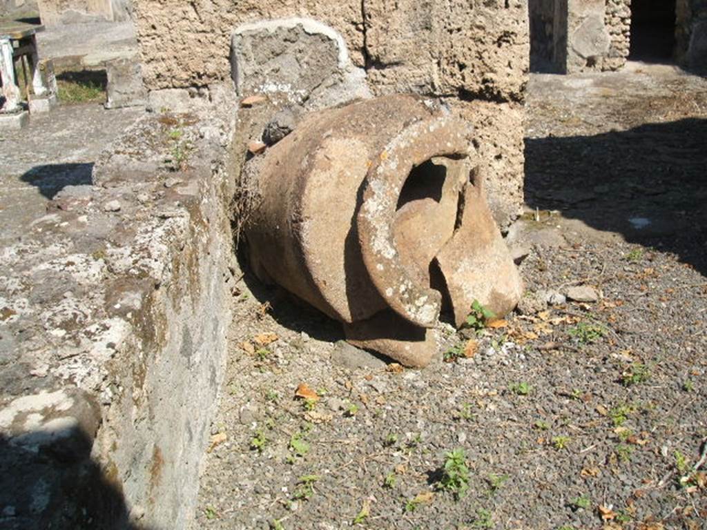 IX.14.4 Pompeii.  May 2005. Broken terracotta pot in corridor I to east of tablinum.  
