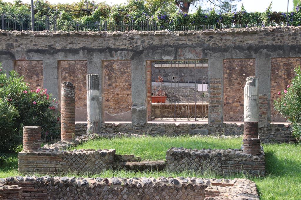 Villa of Diomedes, Pompeii. October 2023. Looking west across pergola towards west wall with doorway/gate. Photo courtesy of Klaus Heese.