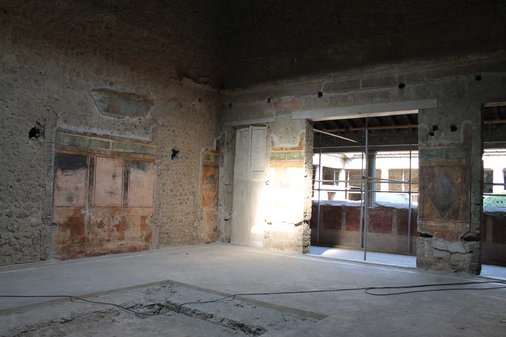 Villa of Mysteries, Pompeii. April 2014. Room 64, looking towards north wall of atrium and north-east corner. 
The doorway to corridor F2 can be seen on the left, on the right is the doorway to the peristyle. 
Photo courtesy of Klaus Heese.
