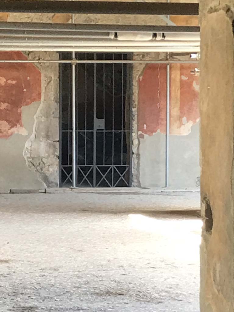 Villa of Mysteries, Pompeii. April 2019. Doorway to room 32, looking to doorway from across peristyle. 
Photo courtesy of Rick Bauer.

