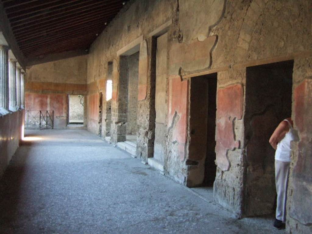 Villa of Mysteries, Pompeii. May 2006. Doorways to rooms 62, 7, 64, 19 and 20 on peristyle A. Looking south along west side.