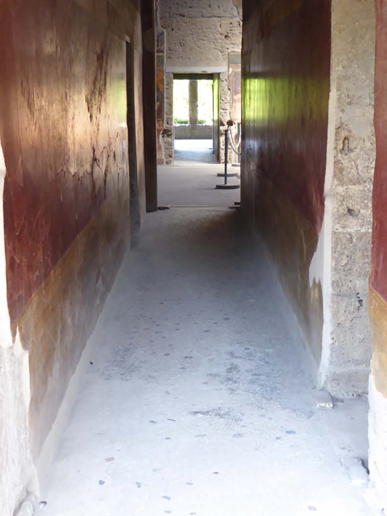 Villa of Mysteries, Pompeii. April 2019. 
Room 64. Looking east across atrium towards blinds with photo of peristyle A imprinted on it, across two of the entrance doorways.
On either side of the impluvium is a display case containing a “body” plaster-cast.
Photo courtesy of Rick Bauer.

