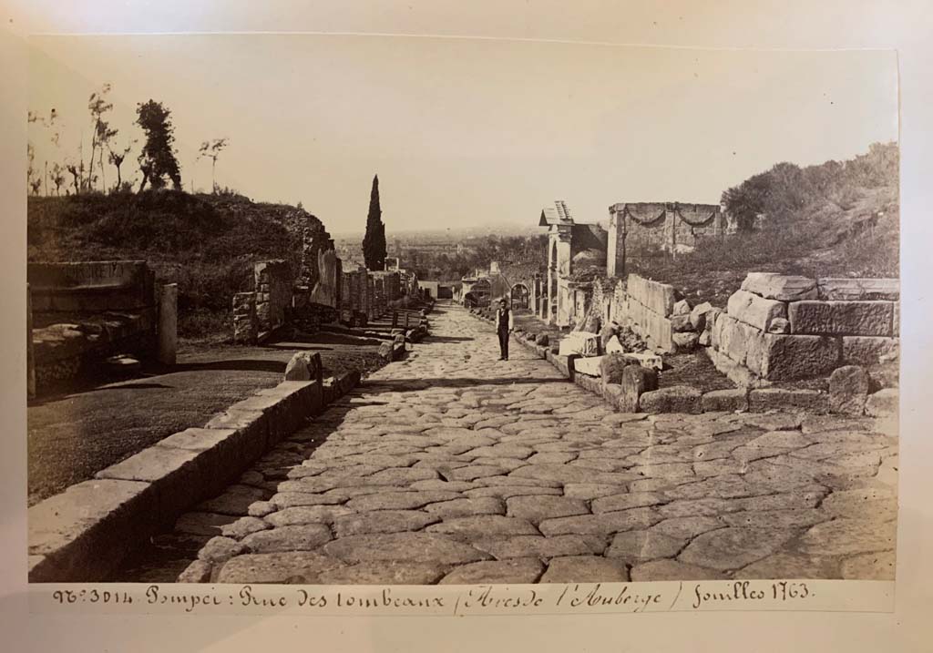 Via dei Sepolcri. 
From an album of Michele Amodio dated 1874, entitled “Pompei, destroyed on 23 November 79, discovered in 1745”. 
Looking north along Via dei Sepolcri from the east part of Via Pomeriale, on right.
The entrance to the west part of Via Pomeriale was on the left where the kerb is missing. Photo courtesy of Rick Bauer.

