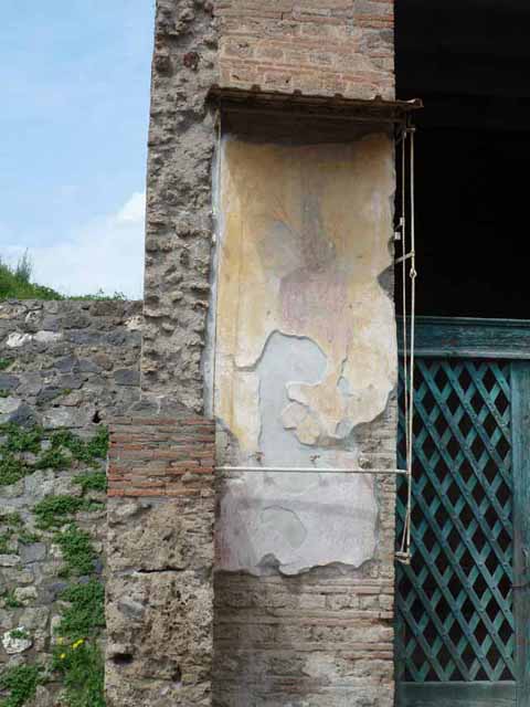 Via dell’Abbondanza, north side. May 2010. Painted figure on the west pilaster of the entrance of III.3.6.