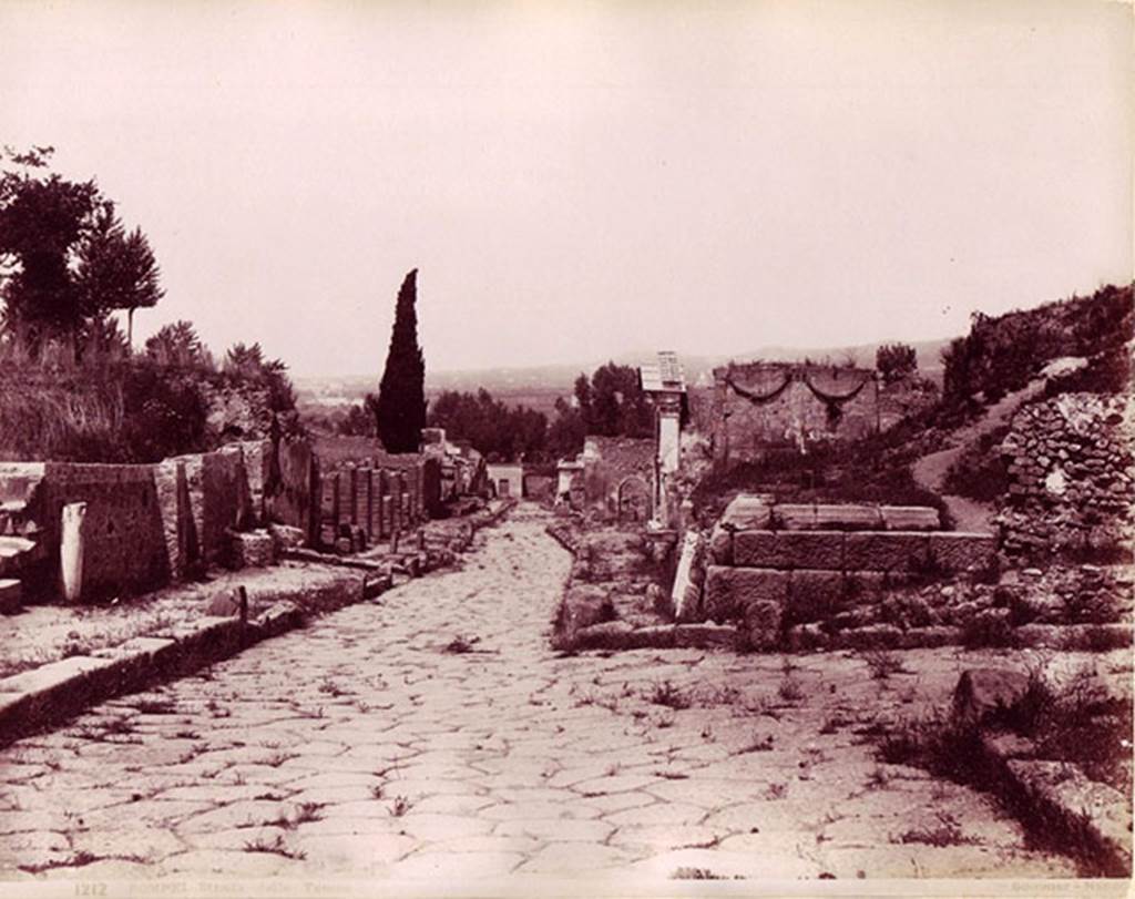 HGE03 Pompeii. Photo by G. Sommer, no. 1212, titled Strada delle Tombe. Looking down the Via dei Sepolcri past Via Pomeriale and HGE03.
According to Kockel, the large marble slab at the front belongs to HGW16. The other architectural fragments likely belong to HGE04.
See Kockel V., 1983. Die Grabbauten vor dem Herkulaner Tor in Pompeji. Mainz: von Zabern, p. 117, taf. 35, taf. 69c.
Photo courtesy of Giovanni Dall'Orto, Wikimedia Commons. See on Wikimedia Commons 
