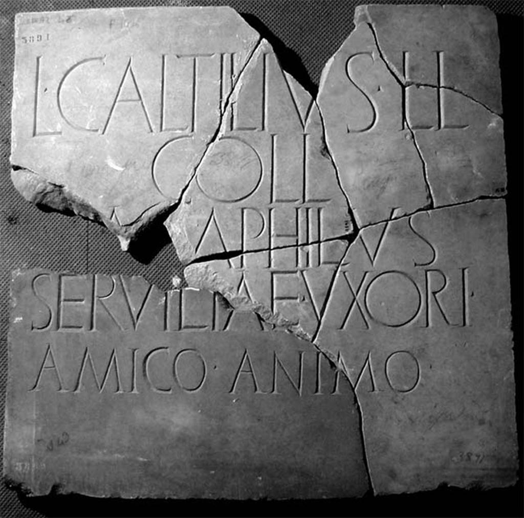 HGE34 Pompeii. Tablet reconstructed in February 2011.
In 2010 Dr Peter Kruschwitz and Virginia Campbell from the University of Reading, UK, identified the piece noted by Clarac (here shown bottom left) as being part of the HGE34 tomb tablet.
This added the name of Servilia, the wife of Lucius and the tablet now translates as
‘Lucius Caltilius Pamphilus, freedman of Lucius, member of the Collinian tribe, for his wife Servilia, in a loving spirit.'
The tablet is now in Naples Archaeological Museum. 
