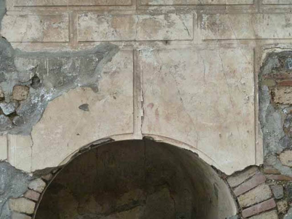 Pompeii Porta Nocera. May 2010. Tomb 12EN, plaster above niche on south side. 