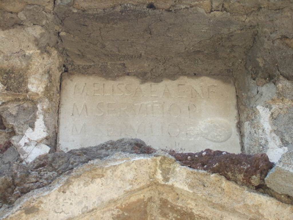 Pompeii Porta Nocera. May 2006. Tomb 32EN, tomb of Lucius Sepunius Sandilianus?  Looking north. 
Two lava cippi were found in front of the tomb.
One had no inscription. The other had the Latin inscription
L(uci)  SEPVNI  L(uci)  F(ili)
SANDIL[ia]N[i]
[i]N  FRONTEM
P(edes)  XX  IN  A[g]R(um)
[P](edes)  XX  PVBLICE
DATVM  EX  D(ecreto)  D(ecurionum).
See D’Ambrosio, A. and De Caro, S., 1983. Un Impegno per Pompei: Fotopiano e documentazione della Necropoli di Porta Nocera. Milano: Touring Club Italiano. (32EN).

