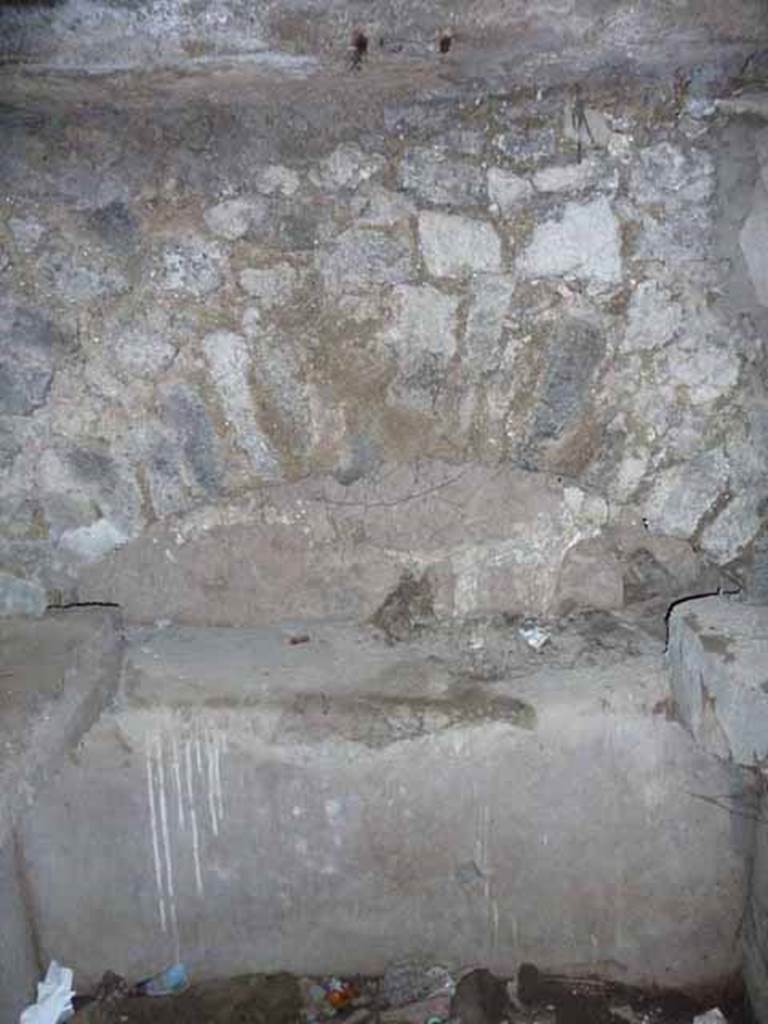 Pompeii Porta Nocera. May 2010. Tomb 7OS. Room on west side of entrance corridor. Niche on west wall. 
In the tomb arch on the west side were three cinerary urns.
The central one was inscribed in carbon, in Greek, AGATHEA FLAVIA.
On the urn on the left was written in Latin ACASTUS.
On the urn on the left was a inscription that had vanished apart from an A.
See D’Ambrosio, A. and De Caro, S., 1983. Un Impegno per Pompei: Fotopiano e documentazione della Necropoli di Porta Nocera. Milano: Touring Club Italiano. (7OS)
