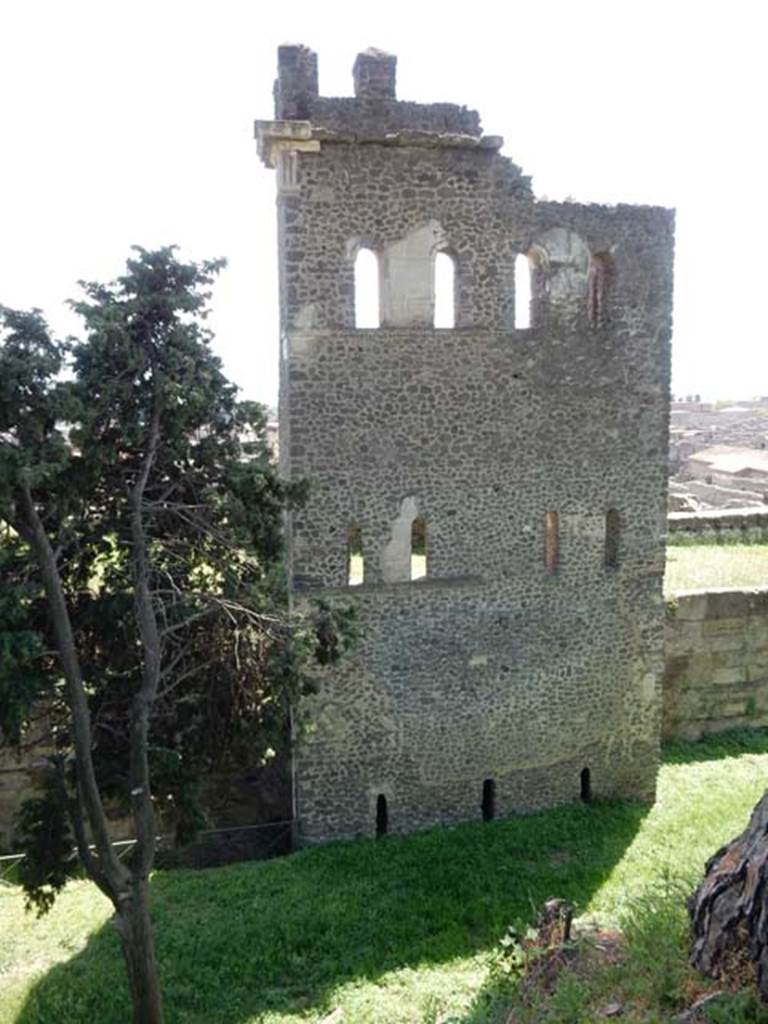 Tower X, Pompeii. May 2015. 
North side of tower, with arrow slit windows on lower floor now level with filled in ground.
Looking south to tower and city walls from walk around walls. Photo courtesy of Buzz Ferebee. 
See Notizie degli Scavi, 1943, (p.275-294), 
for article entitled “Isolation of the wall between Porta Vesuvius and Herculaneum Gate.”
(Isolamento della cinta murale fra Porta Vesuvio e Porta Ercolano).

According to Van der Graaff –
“Tower X seems to have fared better. The arrow slits opening on its flanks were closed at some point in antiquity at an unspecified date. 
However, unlike the two towers farther west, much of the building was probably standing at the time of the eruption. 
Large parts of the structure lay collapsed in volcanic debris on the exterior of the fortifications at the time of excavation. (Note 105).
See Van der Graaff, I. (2018). The Fortifications of Pompeii and Ancient Italy. Routledge, (p.135).




