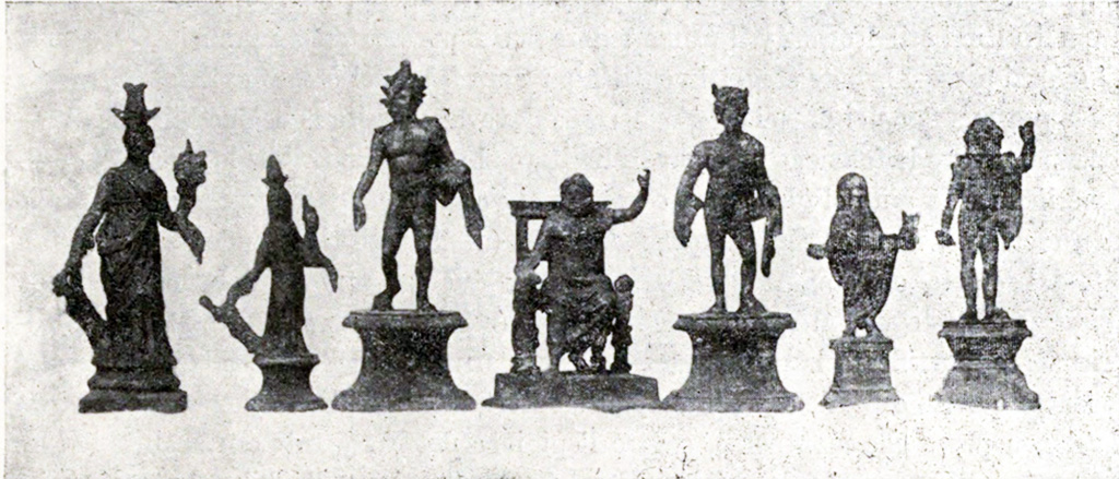 Boscoreale, La villa del Fondo Acunzo. 1903. Room 12.  Podium “y”.
Group of seven bronze statuettes found on podium built against the east wall of the room which opened off the kitchen 8: 
Centre: Jupiter seated
To the left: Helios with radiant crown
Furthest left: Two figures of differing sizes representing Isis-Fortuna
To the right of Jupiter: Mercury or a young nude faun with pan pipes 
Further right: Genius familiaris wearing a toga
Right hand end: Standing Jupiter or Neptune with arm raised

See Notizie degli Scavi di Antichità, 1921, p. 440-1, fig.11.
See Boyce G. K., 1937. Corpus of the Lararia of Pompeii. Rome: MAAR 14.  (p.100, no.500B).
