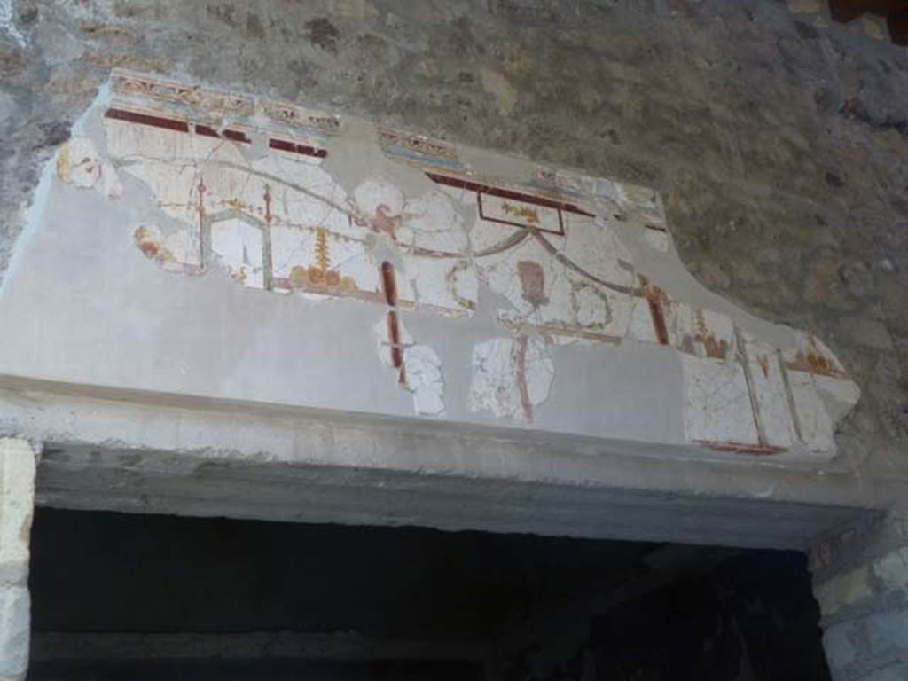 Oplontis, May 2011. Room 23, detail of painted decoration above doorway in portico 24.  Photo courtesy of Michael Binns.

