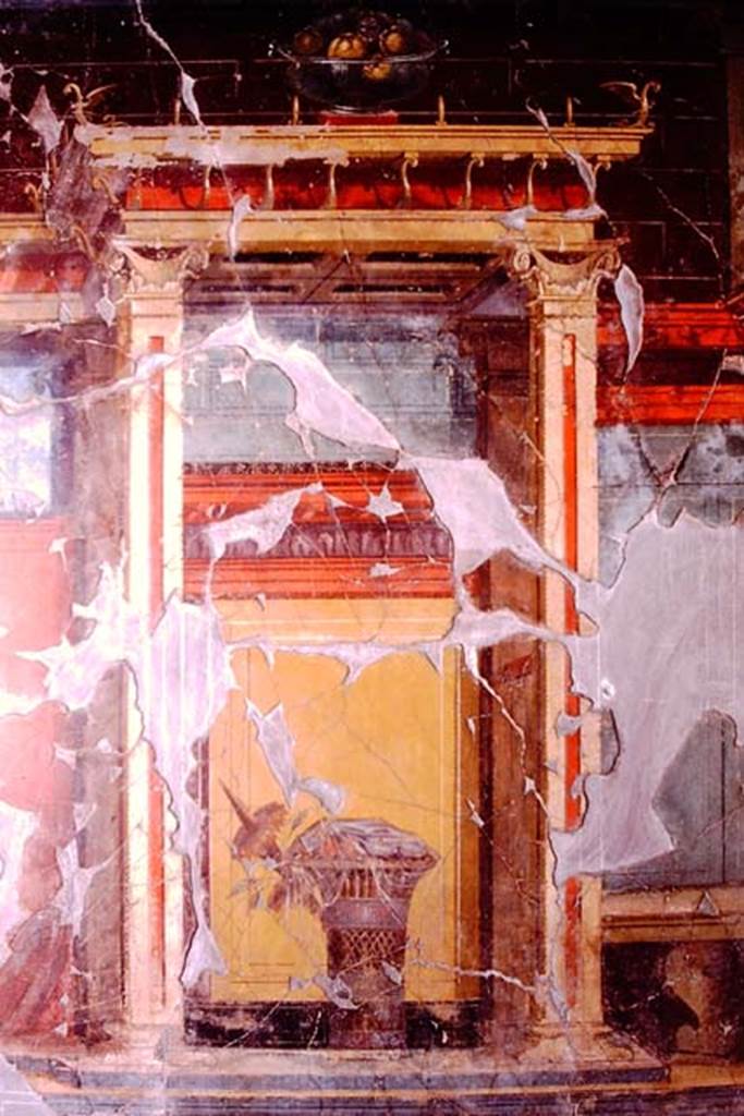 Oplontis, 1974. Room 23, at the top of the wall is a still-life of a glass bowl of pomegranates, and below it is a painted basket of fruit covered with a veil.
Photo by Stanley A. Jashemski.   
Source: The Wilhelmina and Stanley A. Jashemski archive in the University of Maryland Library, Special Collections (See collection page) and made available under the Creative Commons Attribution-Non Commercial License v.4. See Licence and use details. J74f0651
