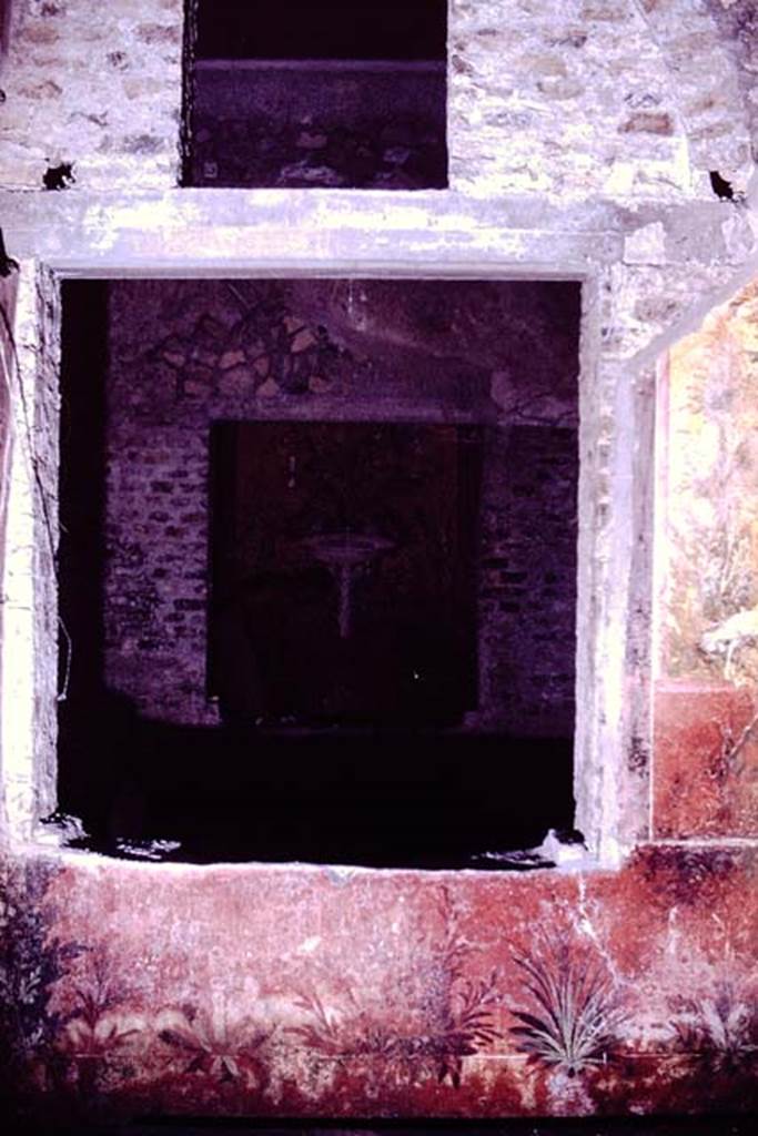 Oplontis, 1976. According to Wilhelmina, this is a window from room 68, a small courtyard-garden where they excavated and found some root-cavities, looking south through the window across room 65, and through another window into room 61.  Photo by Stanley A. Jashemski.   
Source: The Wilhelmina and Stanley A. Jashemski archive in the University of Maryland Library, Special Collections (See collection page) and made available under the Creative Commons Attribution-Non Commercial License v.4. See Licence and use details. J76f0412
According to Wilhelmina, Stanley took many pictures of the garden paintings on the walls of this garden, also of the view from this garden through the adjacent room to the unique little raised garden with garden paintings beyond.

