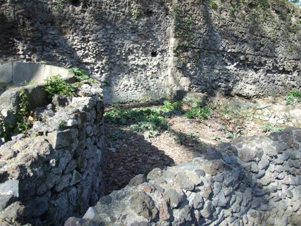 Porta Stabia, Pompeii. March 2009. 
Looking north at tomb of M Tullius, enclosure behind schola with Sarno travertine pier in city wall.
According to Van der Graaff –
“Two sections of opus incertum stretch on either side of the Porta Stabia………………….. 
To the east, the relic of an earlier internal Sarno travertine pier interrupts an otherwise uniform 60 metre stretch of opus incertum masonry.
The pier corresponds to a slight re-entrant in the curtain and the eastern enclosure wall of the schola tomb of Marcus Tullius.
The masonry adjacent to the gate is slightly rougher. It may represent a refurbishment or damage of the wall face associated with the tomb construction or a later partial collapse. At its foot, this section of the wall displays a well-finished surface that must have accommodated a lost plaster veneer. East of the pier, the masonry includes clear horizontal construction seams that marks the sequential deposition of the concrete during the construction process”.
See Van der Graaff, I. (2018). The Fortifications of Pompeii and Ancient Italy. Routledge, (p.115, and Note 24 and 25).


