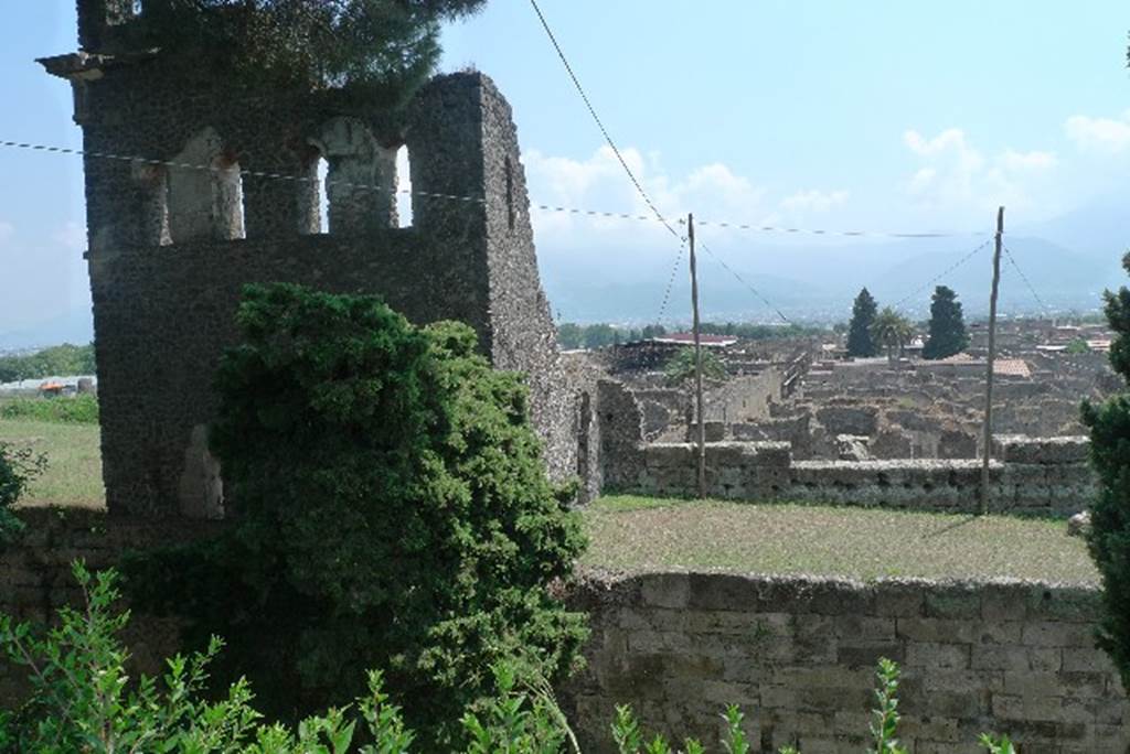 Tower X, Pompeii. July 2010. Photo courtesy of Michael Binns. Looking south from tower and city walls towards Vicolo del Labirinto and VI.11, on right.