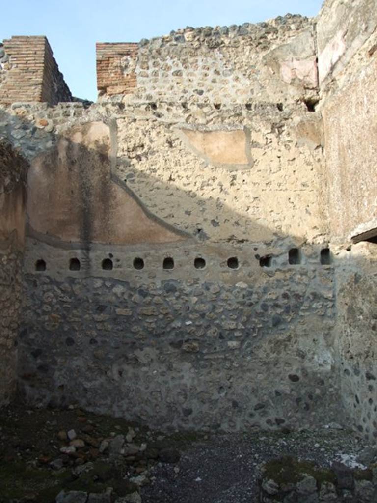 I.4.28 Pompeii. December 2007. Room 27, stables with drinking trough. 
Looking towards north wall with traces of two upper floors and doorway above.

