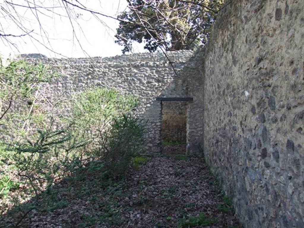 II.1.12 Pompeii.  March 2009.  Looking east on south side of peristyle garden. Doorway into room in south east corner.