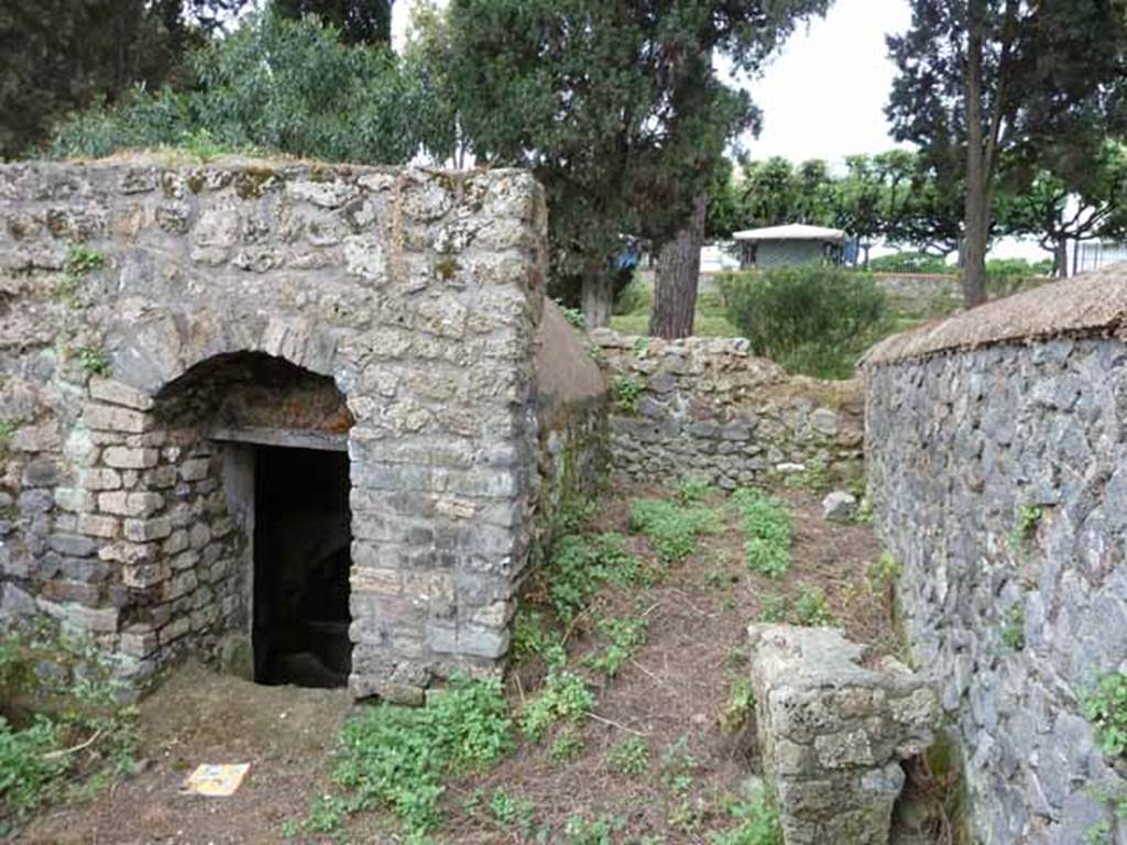 Pompeii Porta Nocera. Tomb 7ES. May 2010. Looking south to entrance to underground room, and area on the right for a funeral banquet. 
